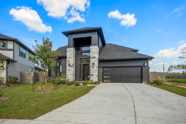 view of front of home with a garage and a front lawn