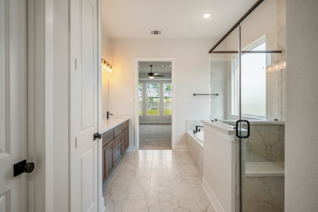 bathroom with tile patterned flooring, separate shower and tub, vanity, and ceiling fan