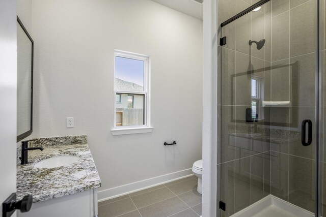 bathroom with walk in shower, tile patterned flooring, toilet, and vanity