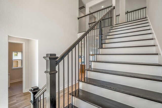 stairway featuring light wood-type flooring