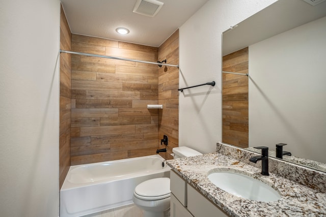 full bathroom featuring toilet, vanity, and tiled shower / bath