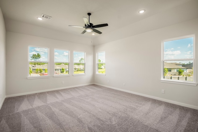 carpeted spare room with ceiling fan