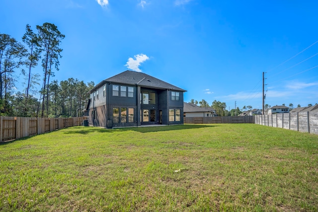 back of house featuring a yard