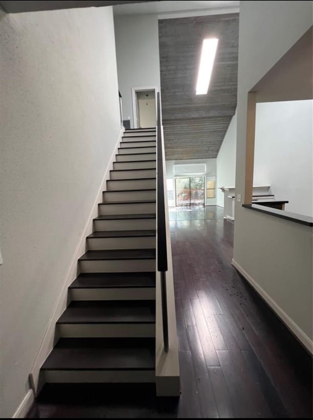 staircase with hardwood / wood-style floors