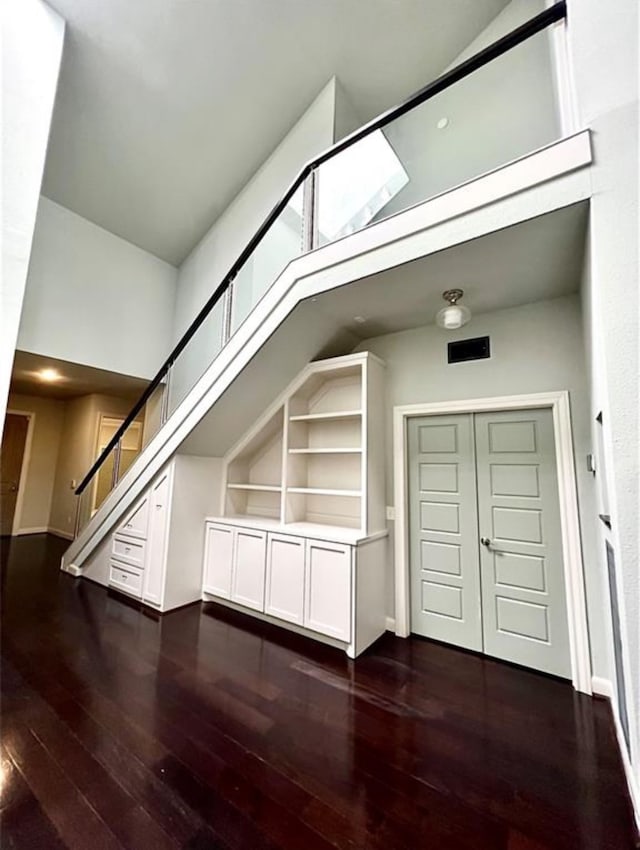 bonus room with dark wood-type flooring