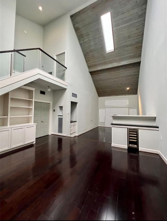 unfurnished living room featuring hardwood / wood-style flooring and high vaulted ceiling