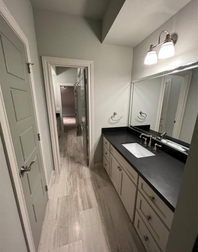 bathroom featuring hardwood / wood-style flooring and vanity