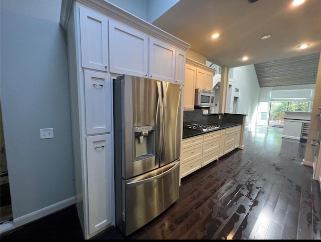 kitchen with backsplash, white cabinetry, dark wood-type flooring, and appliances with stainless steel finishes