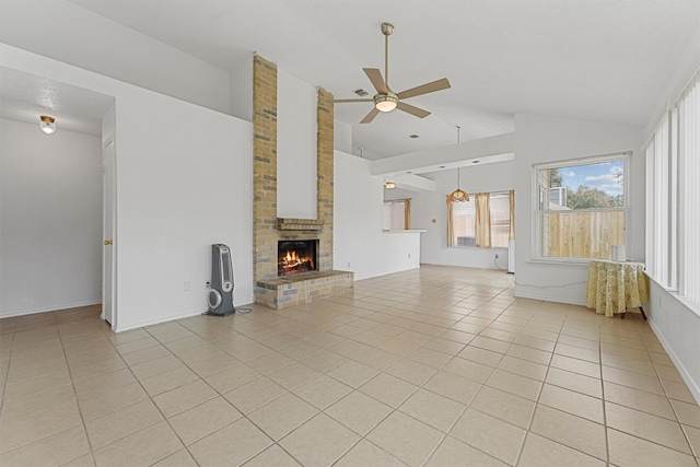 unfurnished living room featuring a fireplace, ceiling fan, brick wall, vaulted ceiling, and light tile patterned floors