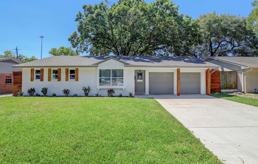 ranch-style house with a garage and a front yard