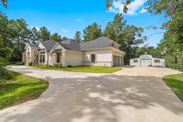 view of front of house featuring a garage and a front lawn