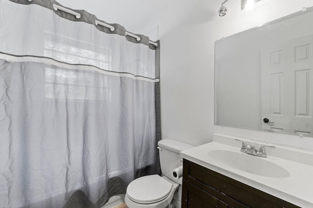 bathroom featuring toilet, shower / tub combo, and vanity