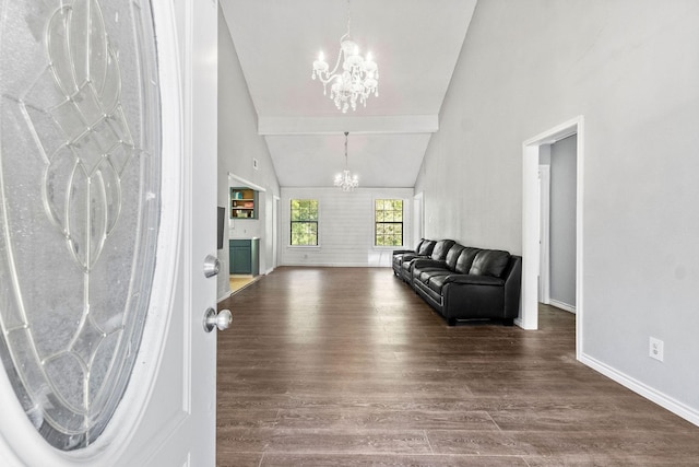 entrance foyer featuring vaulted ceiling with beams, a chandelier, and wood-type flooring