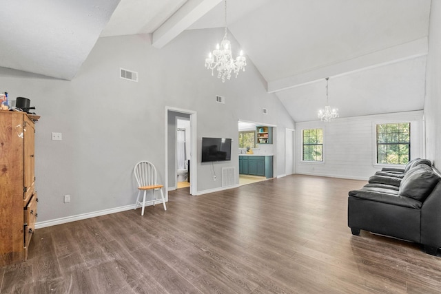 living room featuring an inviting chandelier, beam ceiling, and hardwood / wood-style floors