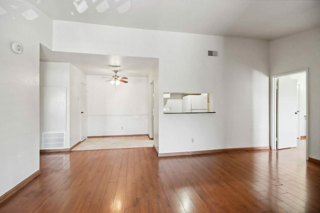 unfurnished living room with hardwood / wood-style flooring and ceiling fan