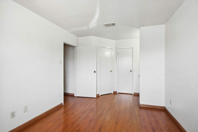 unfurnished bedroom featuring hardwood / wood-style flooring