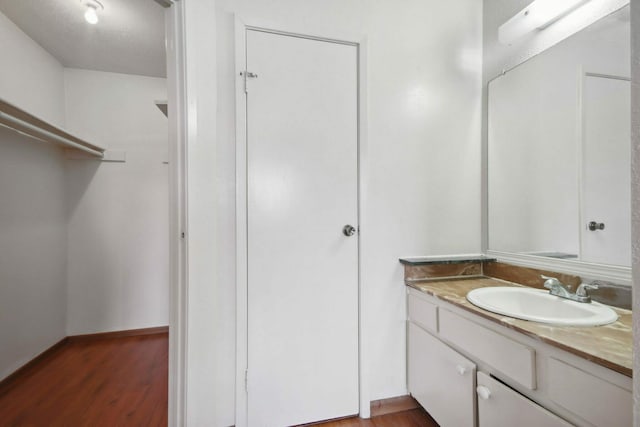 bathroom featuring vanity and wood-type flooring