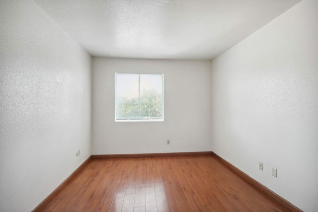 unfurnished room featuring wood-type flooring