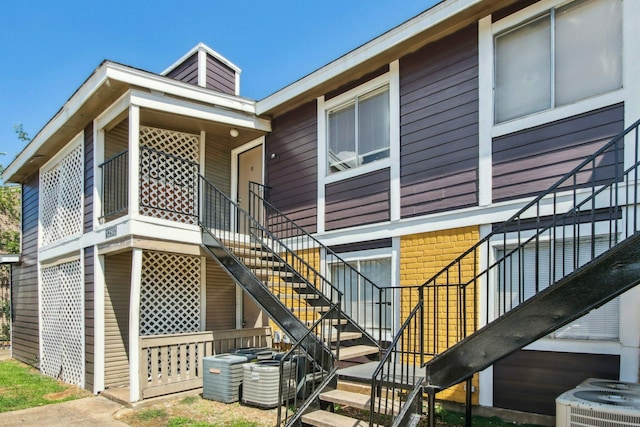 rear view of house featuring central air condition unit