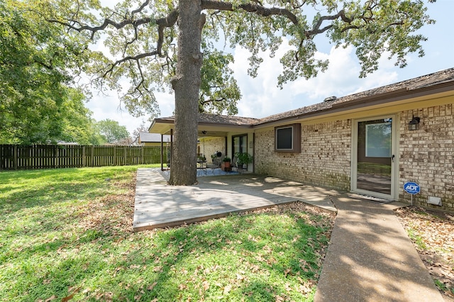 rear view of house featuring a lawn and a patio area