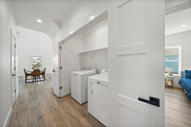 washroom with hardwood / wood-style floors and washer and dryer