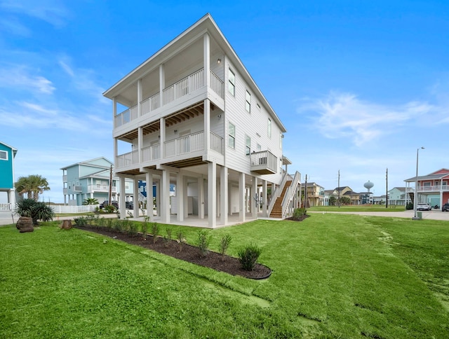 back of house featuring a patio area, a yard, and a balcony