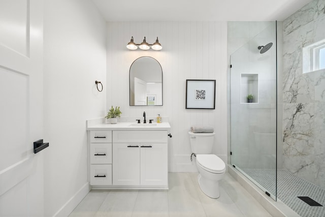 bathroom featuring tile patterned flooring, vanity, toilet, and walk in shower