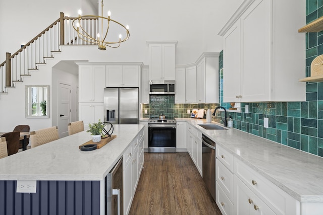 kitchen featuring stainless steel appliances, a kitchen island, dark wood-type flooring, sink, and wine cooler