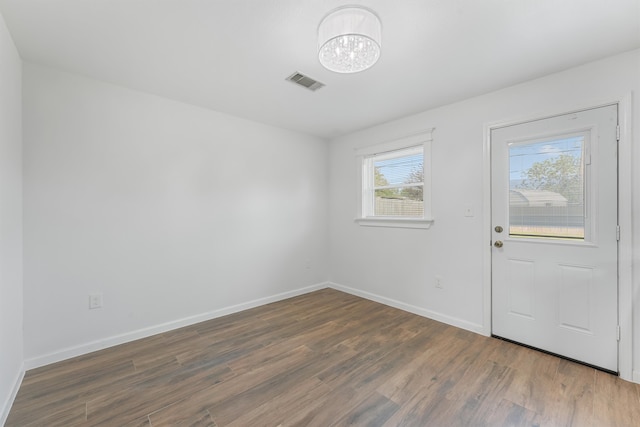 interior space featuring hardwood / wood-style floors and a chandelier