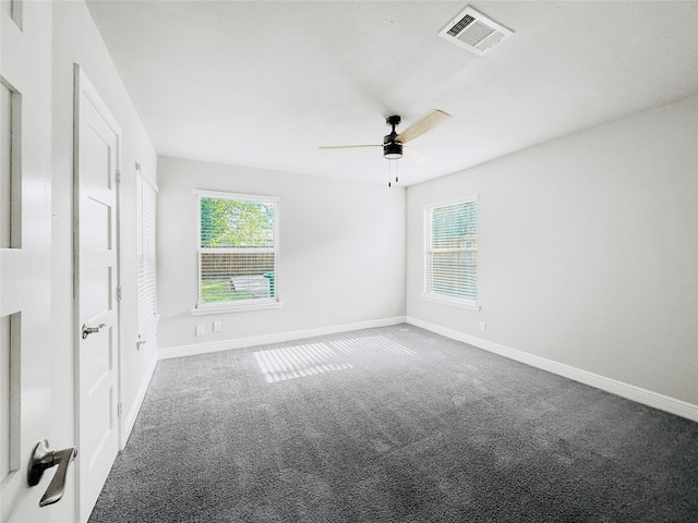 carpeted spare room with ceiling fan