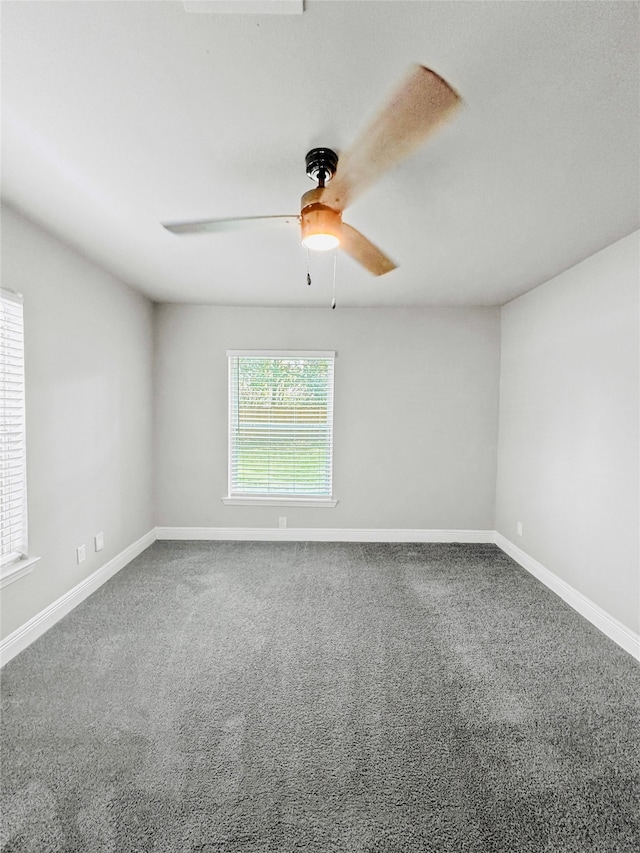 unfurnished room with ceiling fan and carpet floors