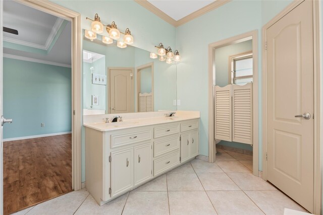 bathroom with tile patterned floors, toilet, vanity, and crown molding