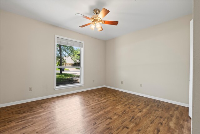 unfurnished room with ceiling fan and dark wood-type flooring