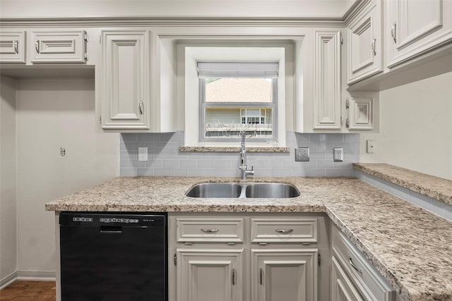 kitchen with sink, black dishwasher, white cabinetry, and decorative backsplash