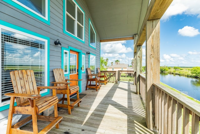 wooden deck featuring a water view