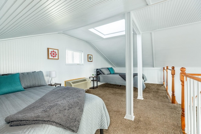 bedroom with carpet, vaulted ceiling with skylight, and a wall unit AC