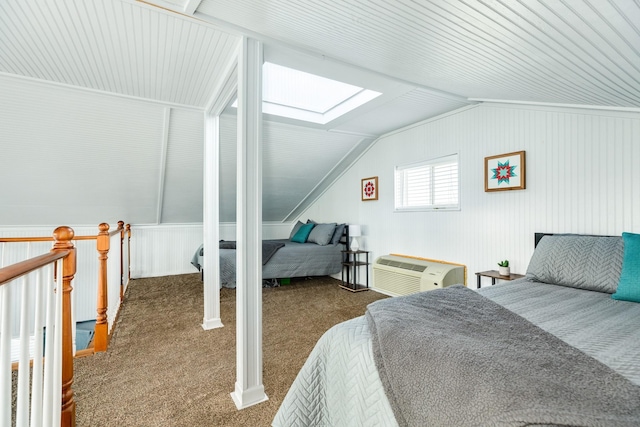carpeted bedroom with a wall unit AC and lofted ceiling with skylight