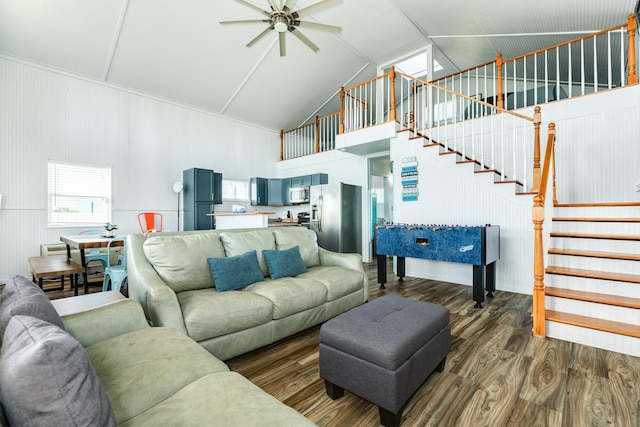 living room with ceiling fan, dark hardwood / wood-style floors, and high vaulted ceiling