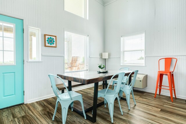 dining room with wood-type flooring and a healthy amount of sunlight