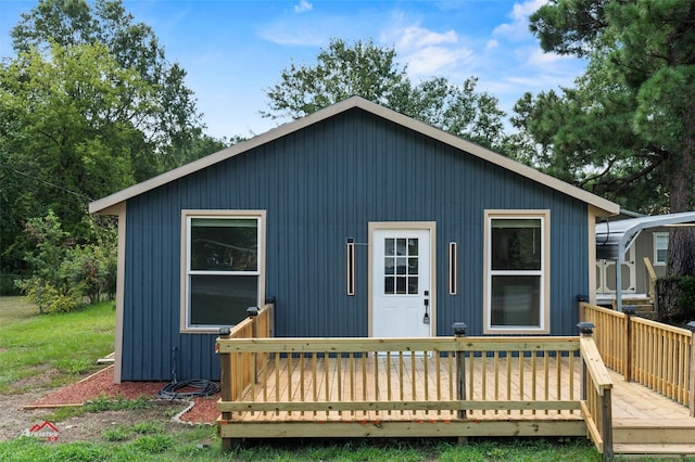 rear view of house featuring a deck