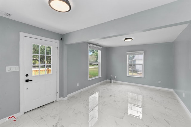 doorway featuring plenty of natural light and light tile patterned floors