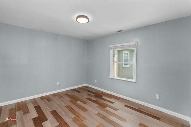 empty room with light hardwood / wood-style flooring