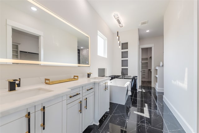 bathroom with a bathtub, tile patterned flooring, and dual vanity