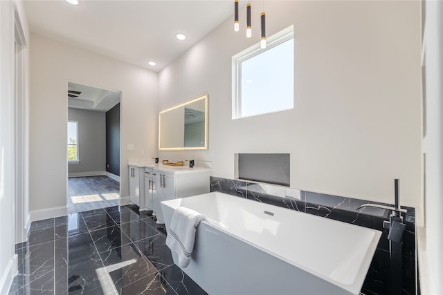 bathroom featuring vanity, a bathtub, and tile patterned flooring