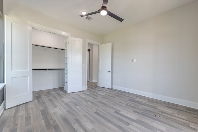 unfurnished bedroom with light wood-type flooring, a closet, and ceiling fan