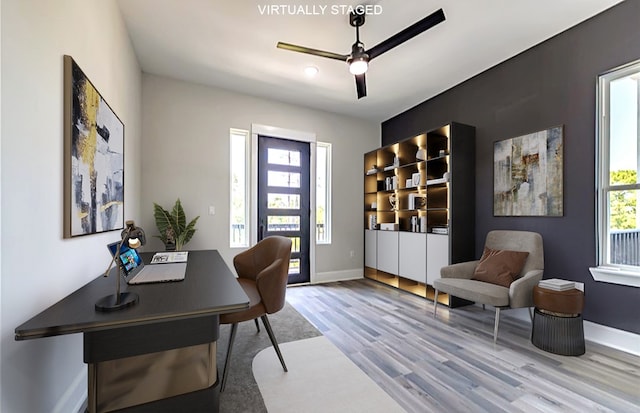 home office featuring ceiling fan and light hardwood / wood-style floors