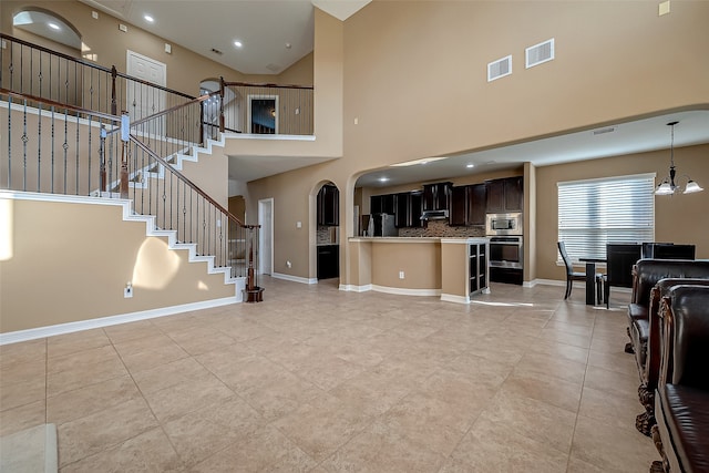 living room featuring a high ceiling and an inviting chandelier