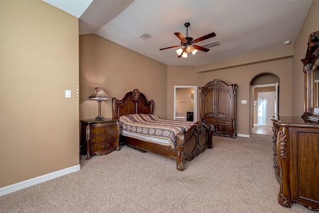 bedroom featuring ceiling fan, light colored carpet, and vaulted ceiling