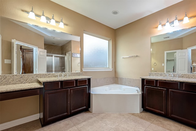 bathroom with independent shower and bath, vanity, and tile patterned flooring