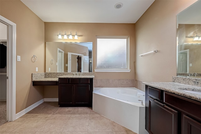 bathroom with vanity, a tub to relax in, and tile patterned flooring